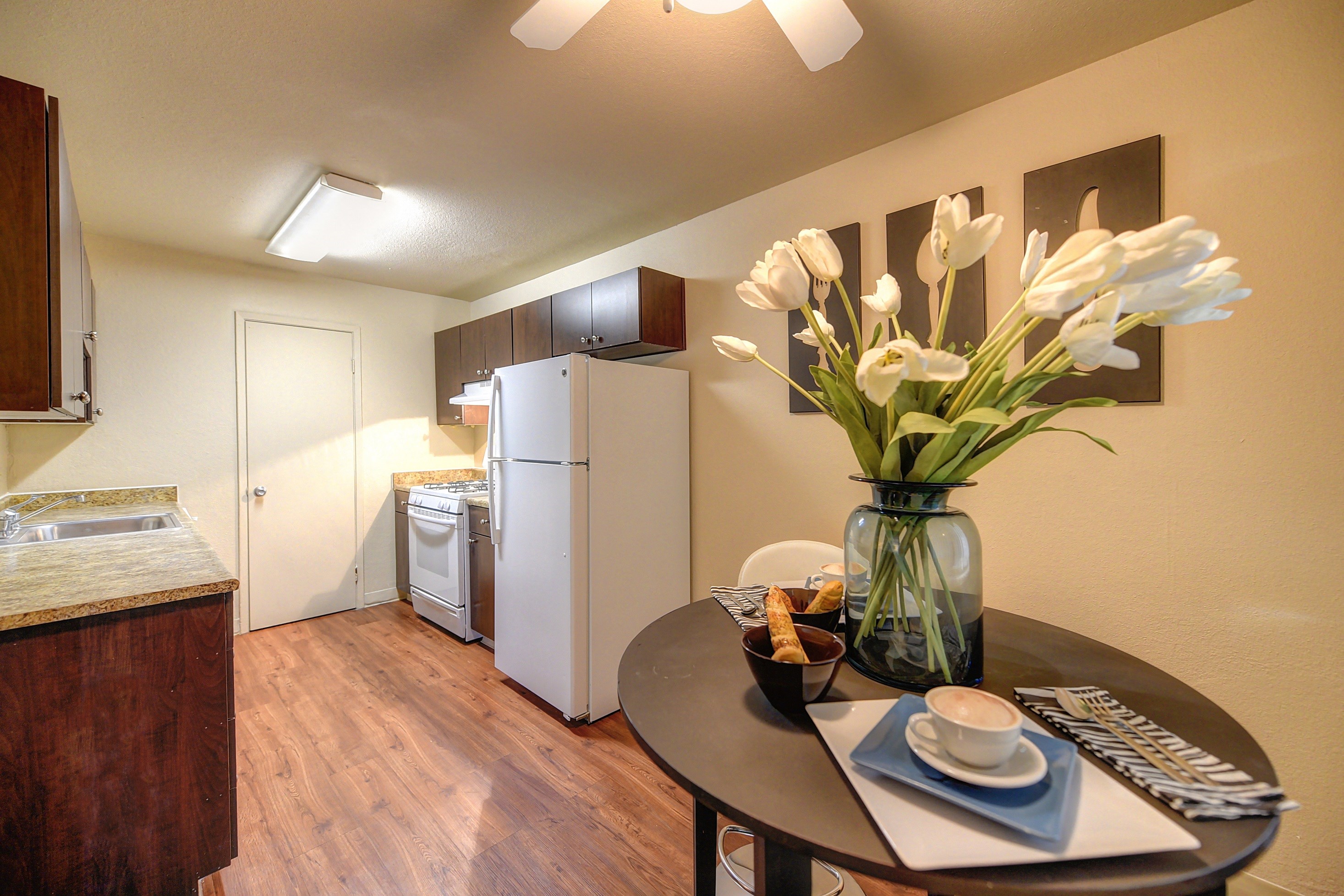 Kitchen Dining Area Room Granite Quartz Counter Countertop, Refrigerator, Gas Range Stove, Hardwood Inspired Wood Floor